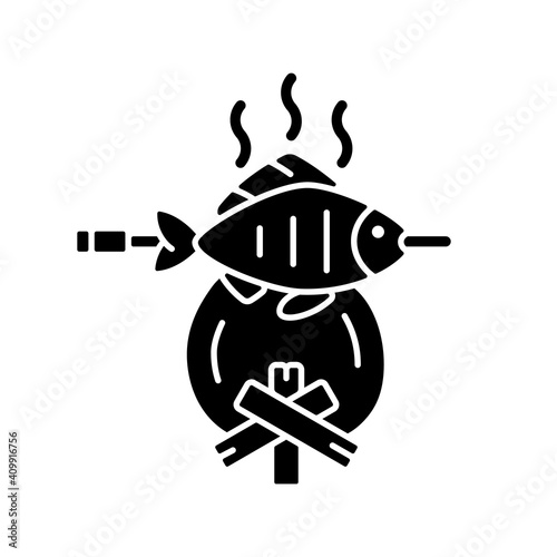 Cooking freshly caught fish black glyph icon. Fres sea food idea. Hobby and leasure activities. Making a fire. Outdoor cooking. Silhouette symbol on white space. Vector isolated illustration
