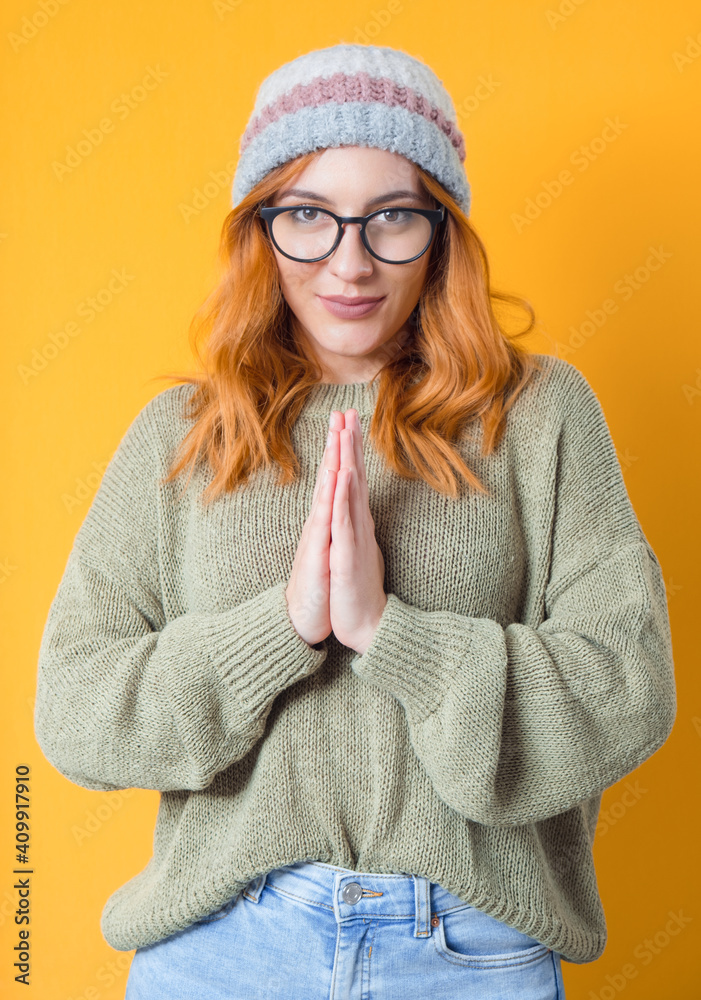 Calm woman, isolated on yellow background. Meditation concept. Pretty girl