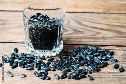 sunflower seeds in a glass on a wooden table photo