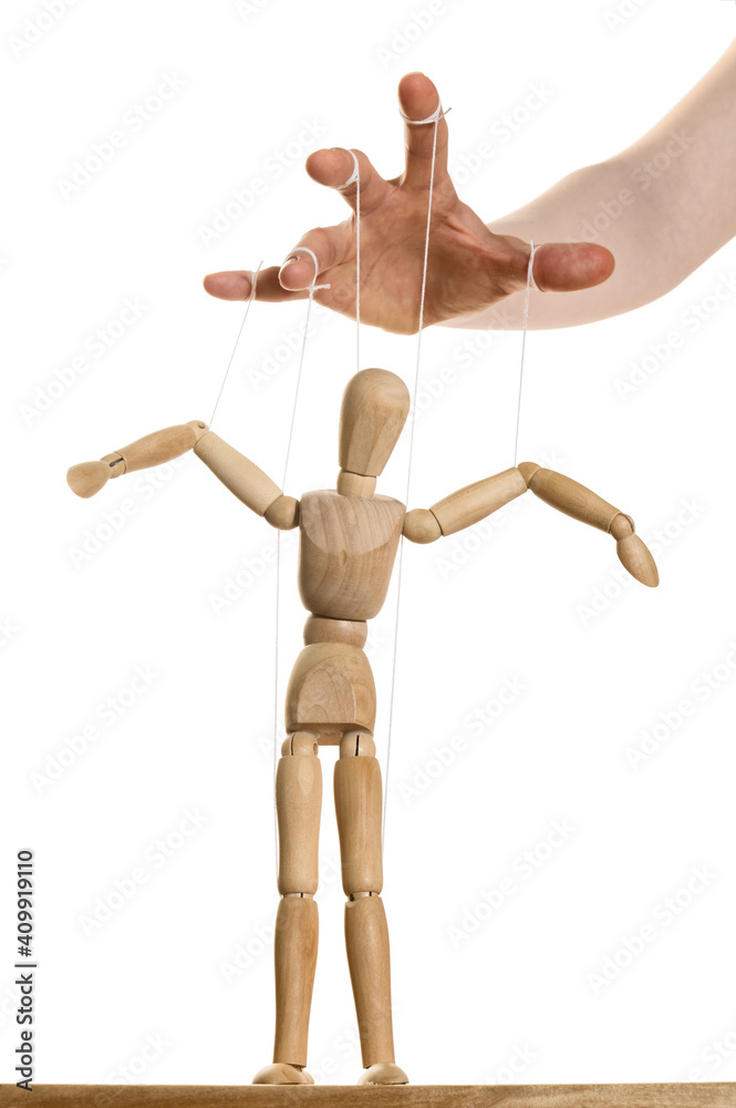 Concept of control. Marionette in human hand. Stock Photo