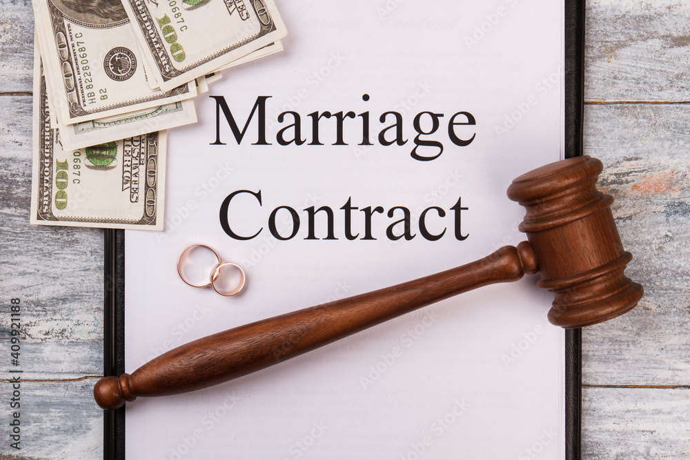 Marriage contract concept. Wooden gavel wedding rings and money top view. Marriage contract concept. Wooden gavel wedding rings and money top view.