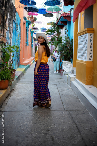Beautiful Colombian woman with colorful outfit in the old city of Cartagena, Colombia © Allen.G