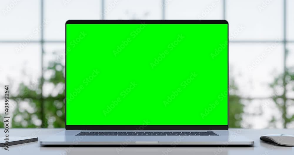 Laptop with blank green screen in office interior. Smooth camera movement with bokeh background. Home interior or office, 4k 60fps UHD