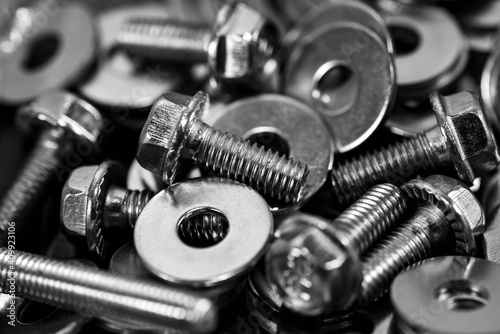 Monochrome image, bolts washers and nuts close up macro shot for industrial background.