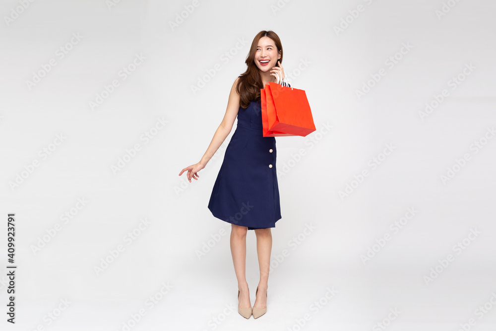 Asian woman holding shopping bags in full body isolated on white background, Shopper or shopaholic concept