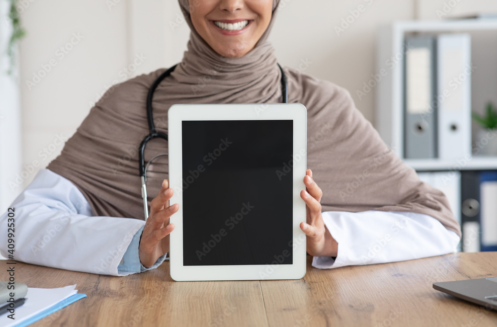 Cropped of female doctor showing digital tablet with blank screen Cropped of female doctor showing digital tablet with blank screen