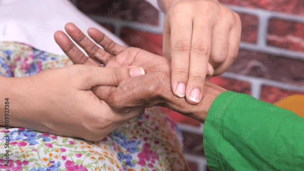 female doctor measuring pulse of elderly women female doctor measuring pulse of elderly women