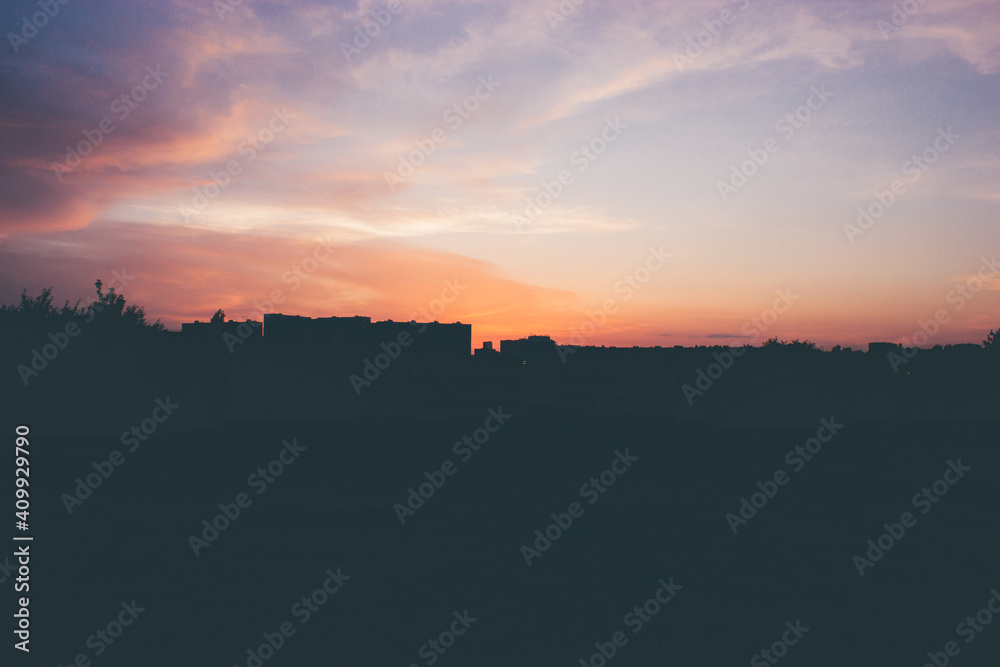 Beautiful bright sunset with cloudscape and multicolored evening glowing over skyline