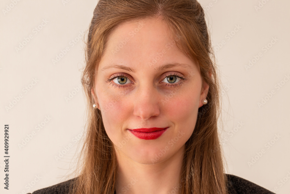 Young businesswoman smiling on bright background from close up. Blonde professional worker in detal. Portrait of positive working female. Young businesswoman smiling on bright background from close up. Blonde professional worker in detal. Portrait of positive working female.