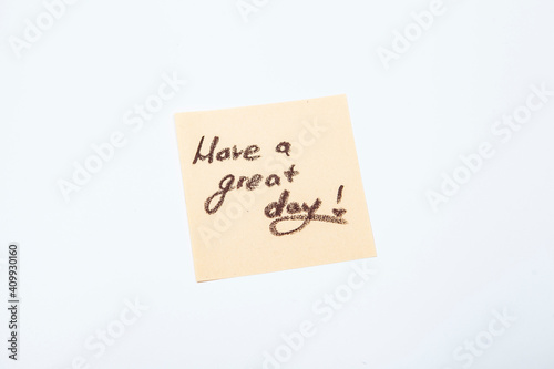 Have a great day message handwritten on yellow post-it note