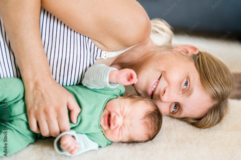 Happy mother with crying newborn Happy mother with crying newborn