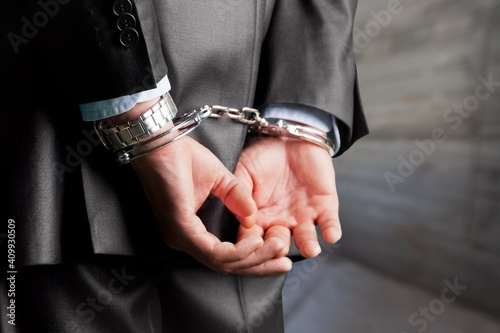 Criminal man with his hands in handcuffs