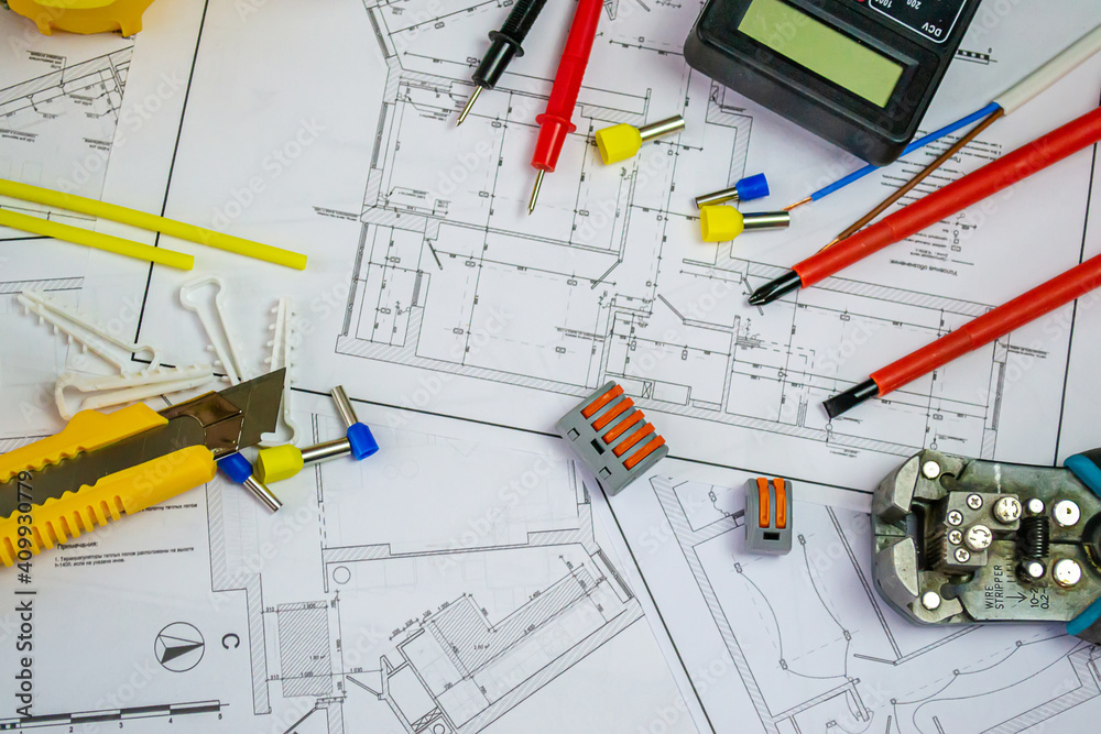 Flat lay composition with electrician's tools on house plan. Space for text Flat lay composition with electrician's tools on house plan. Space for text