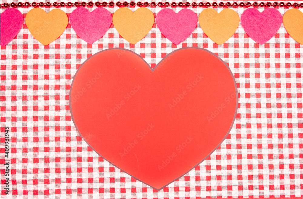 background with red and white Vichy fabric for Valentine's Day with pink, red and orange hearts and a big red heart in the middle. valentines day concept