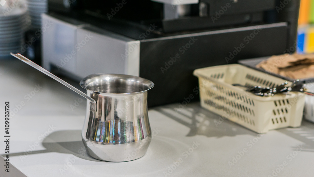 the waitress is preparing latte and Coffee in a white cup with milk foam in a coffee maker the waitress is preparing latte and Coffee in a white cup with milk foam in a coffee maker
