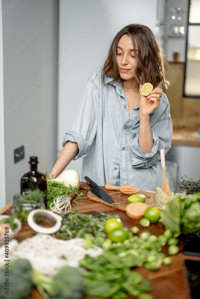 Pretty woman with green ingredients thinking about cooking healthy food on the kitchen. Healthy and wellness concept. High quality photo Pretty woman with green ingredients thinking about cooking healthy food on the kitchen. Healthy and wellness concept. High quality photo