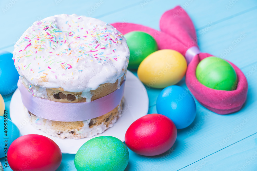 Easter cake and colorful Easter eggs close-up top view, selective focus, tinted image Easter cake and colorful Easter eggs close-up top view, selective focus, tinted image
