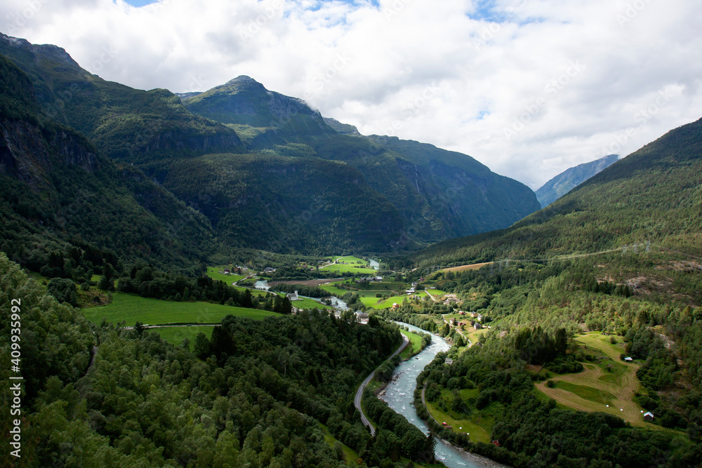 Village in the valley in the middle of mountains and forests in Norwegian rural countryside. Norway