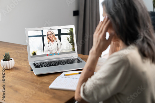 Video conference with a doctor, video consultation online. A female doctor, therapy recommends treatment, advises herapy to senior woman via video connection. Telemedicine concept photo