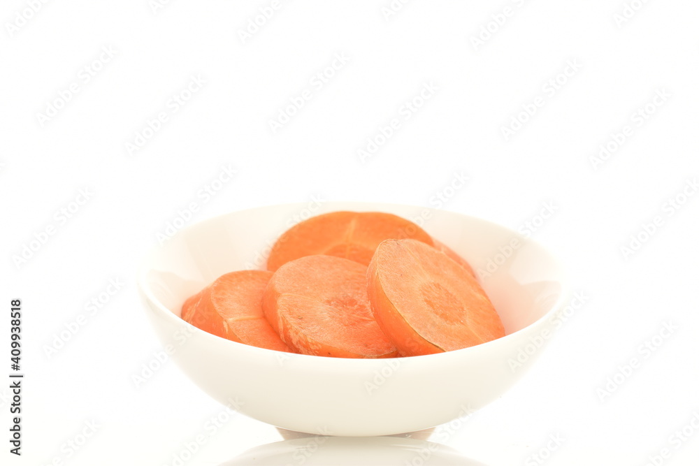 Several slices of ripe organic, unpeeled carrots in a white ceramic saucer, close-up, isolated on white. Several slices of ripe organic, unpeeled carrots in a white ceramic saucer, close-up, isolated on white.