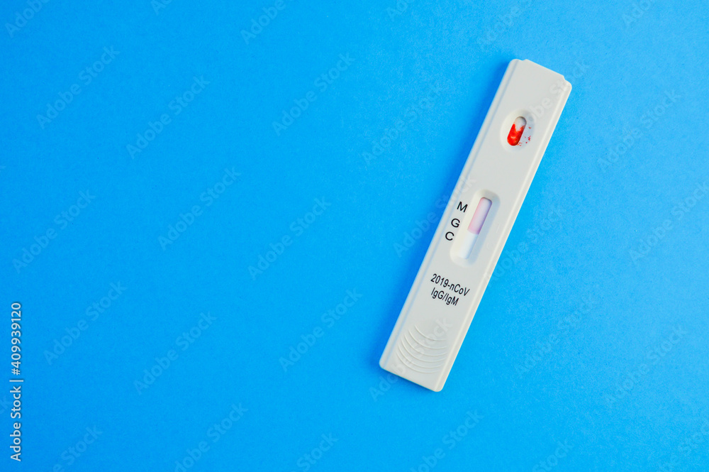 coronavirus test lies on a blue background. a drop of venous blood on the test strip. medical laboratory, express diagnostics of coronavirus. the test shows the presence of IgG and IgM antibodies coronavirus test lies on a blue background. a drop of venous blood on the test strip. medical laboratory, express diagnostics of coronavirus. the test shows the presence of IgG and IgM antibodies