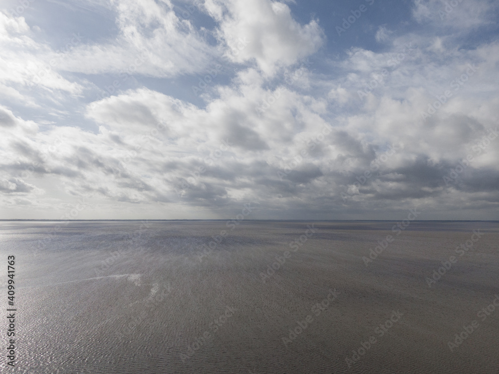 Landscape at the sea from above. Drone flight over the ocean. Beautiful waterside and sky
