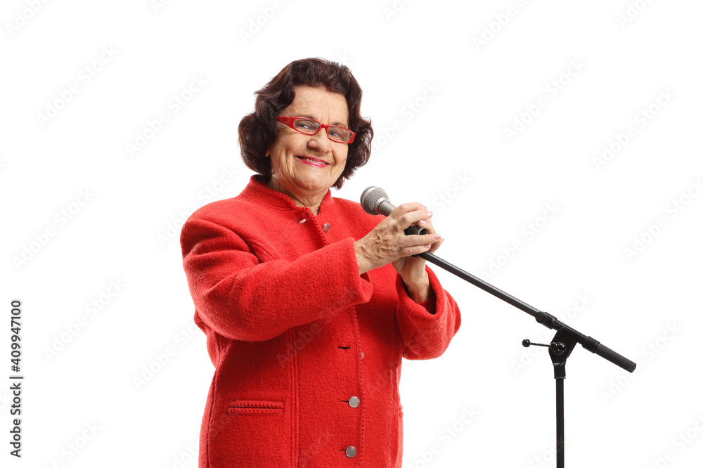 Fototapeta premium Elderly woman with a microphone smiling at the camera