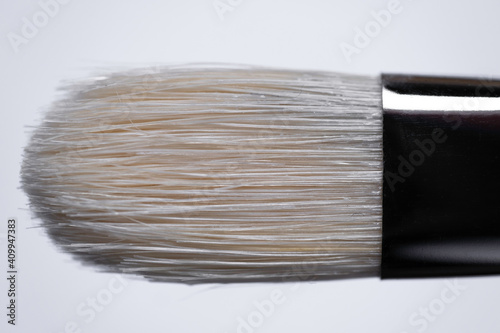 Cat tongue brush made of white Chinese Chungking pig bristles in a nickel-plated brass can. Suitable for oil painting. On white background photo