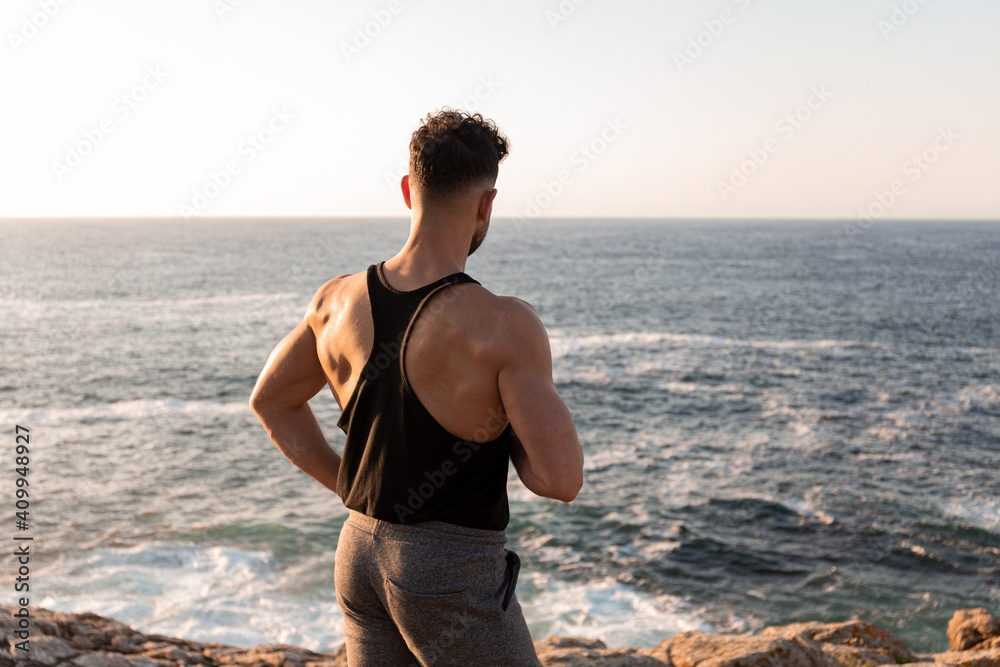 Portrait of a muscular athlete in white fitness attire. Confident  sportswoman standing outdoors taking a break stock photo (272771) -  YouWorkForThem