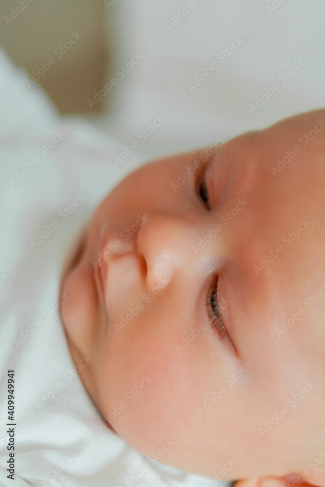 Close-up. Baby. Beautiful young happy mom and baby. Mom holds the baby in her arms.