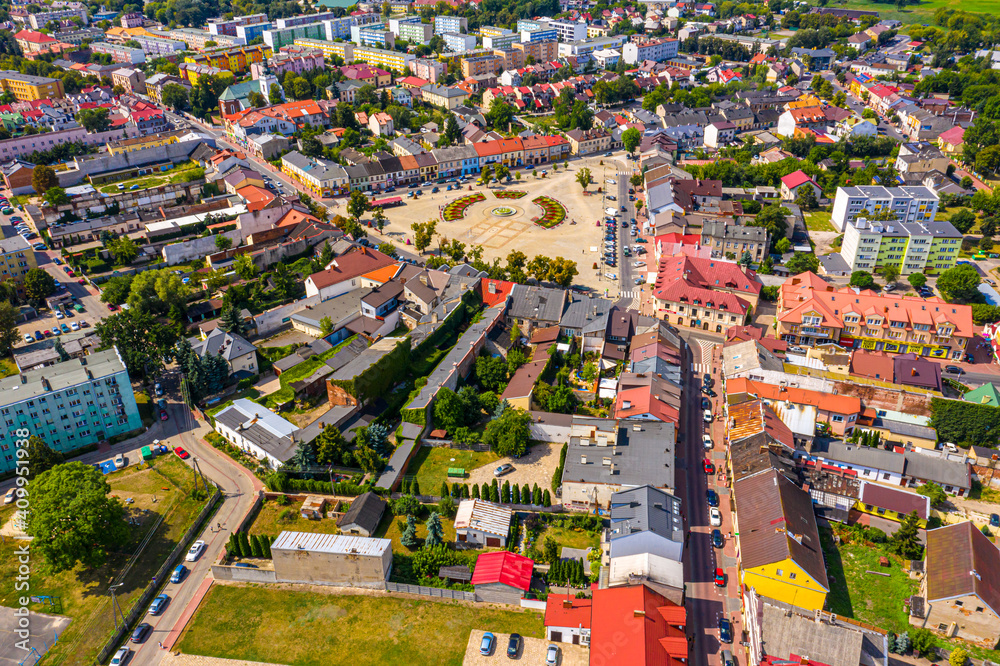 Top aerial panoramic view of Lowicz old town historical city centre with Rynek Market Square, Old Town Hall, New City Hall, colorful buildings with multicolored facade and tiled roofs, Poland