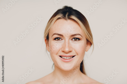 Smiling young adult caucasian woman close up full face portrait