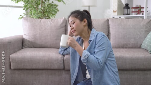 Wallpaper Mural lovely smiling young asian japanese woman sitting by the couch and enjoying carefree Sunday with cup of hot coffee Torontodigital.ca