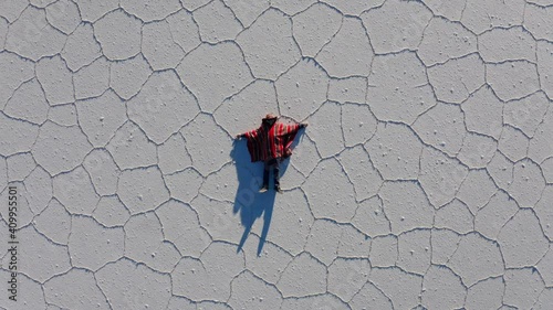 Man in poncho at Salar de Uyuni, Aitiplano, Bolivia. Traveling in Bolivia