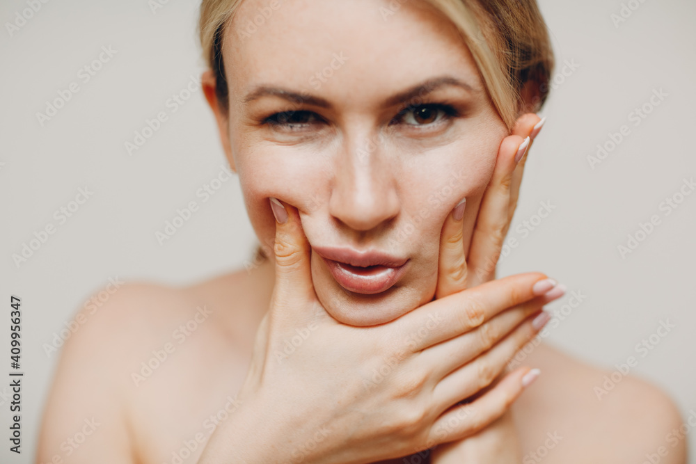 Young adult doing facial gymnastics self massage and rejuvenating exercises face building for skin and muscles lifting Young adult doing facial gymnastics self massage and rejuvenating exercises face building for skin and muscles lifting