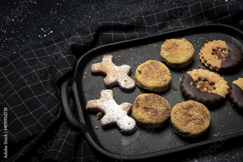 From above of delicious baked homemade cookies placed on tray on black table in kitchen photo