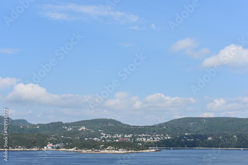land and mounatins across the blue ocean on a summer day