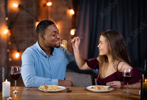 Cheerful Interracial Couple Having Fun During Romantic Dinner At Home