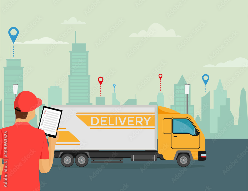 Naklejka premium Delivery courier holds a tablet in his hand with a truck on the background.