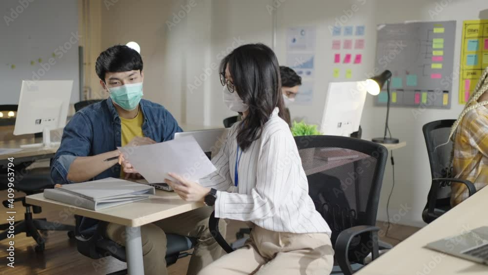 New normal working and lifestyle in office concept.Group of young asian creative business wearing mask working and brain storm meeting,planning,strategy,new business development in office. New normal working and lifestyle in office concept.Group of young asian creative business wearing mask working and brain storm meeting,planning,strategy,new business development in office.