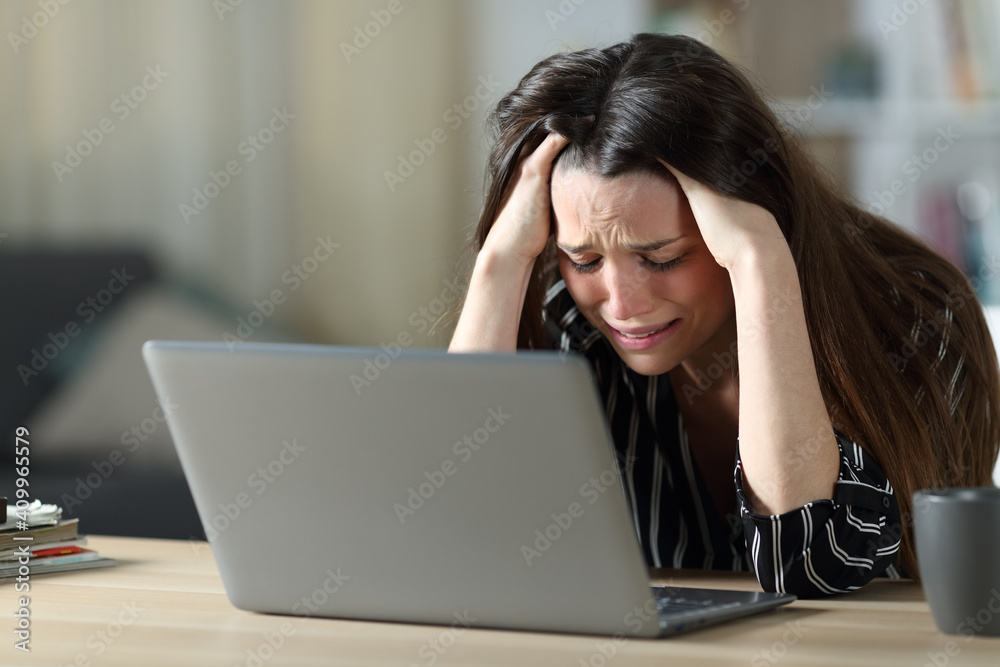 Sad woman complaining reading laptop content Sad woman complaining reading laptop content