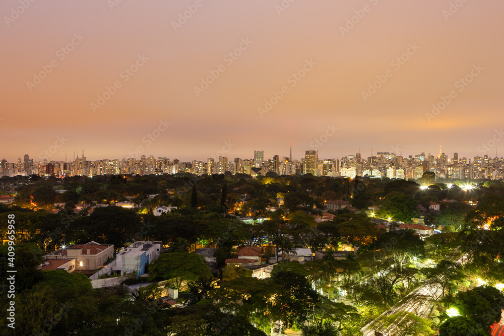 Fototapeta premium Aerial view of São Paulo city skyline at night, park, streets, houses, trees and buildings in the background at dusk. Concept of urban, city, architecture, cityscape, metropolis, business, tourism.