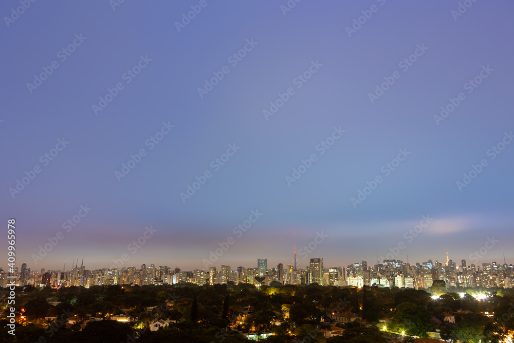 Obraz premium Aerial view of São Paulo city skyline at night, park, streets, houses, trees and buildings in the background at dusk. Concept of urban, city, architecture, cityscape, metropolis, business, tourism.