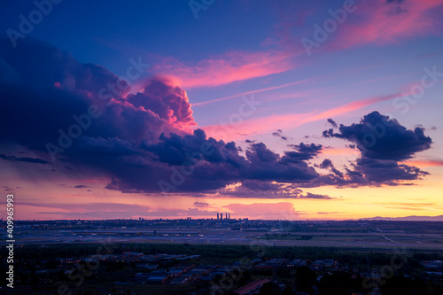 Spectacular scenery of Madrid city under colorful cloudy sky at sundown in Spain