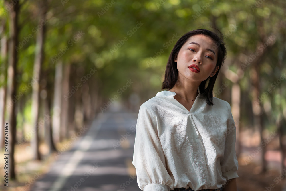 Ethnic Asian female walking in Tanya Shen Green Bikeway looking at camera Ethnic Asian female walking in Tanya Shen Green Bikeway looking at camera