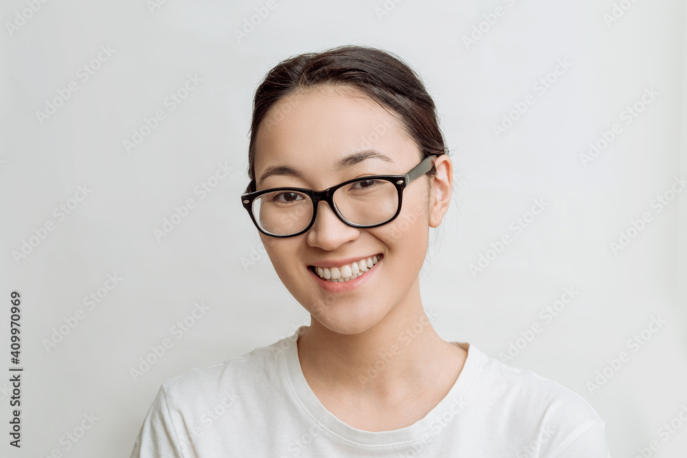 asian young woman wearing glasses for vision on a white background. happy attractive woman smiles asian young woman wearing glasses for vision on a white background. happy attractive woman smiles