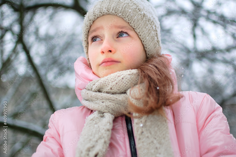 Little upset girl is wearing pink clothes in the park and crying. Unhappy kid got frozen spending time outdoors during cold winter Little upset girl is wearing pink clothes in the park and crying. Unhappy kid got frozen spending time outdoors during cold winter