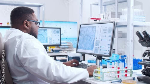 Wallpaper Mural Professional African-American scientist is working on a vaccine in a modern scientific research laboratory. Genetic engineer workplace. Futuristic technology and science concept. Torontodigital.ca