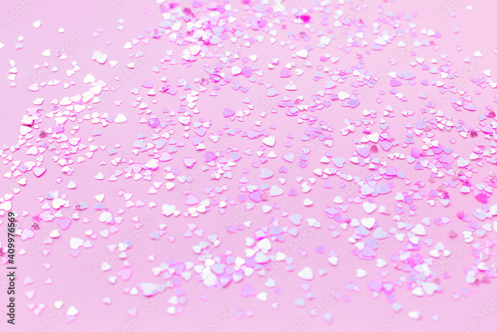 Abstract background of pink heart-shaped sparkles.