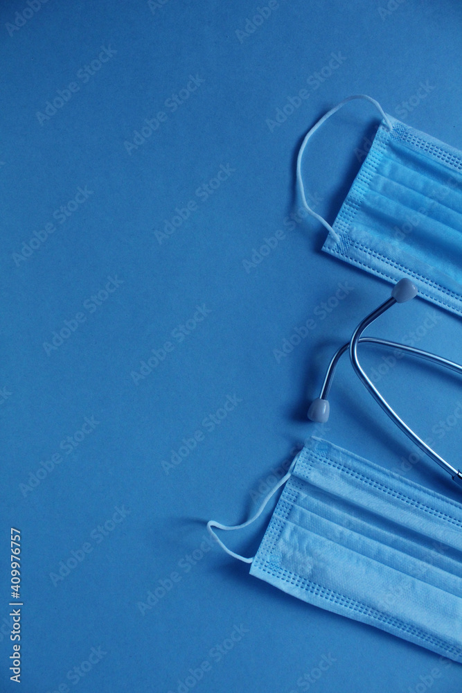 background of the medical mask and stethoscope on a blue blue background with a place for the text of the copyspace background of the medical mask and stethoscope on a blue blue background with a place for the text of the copyspace